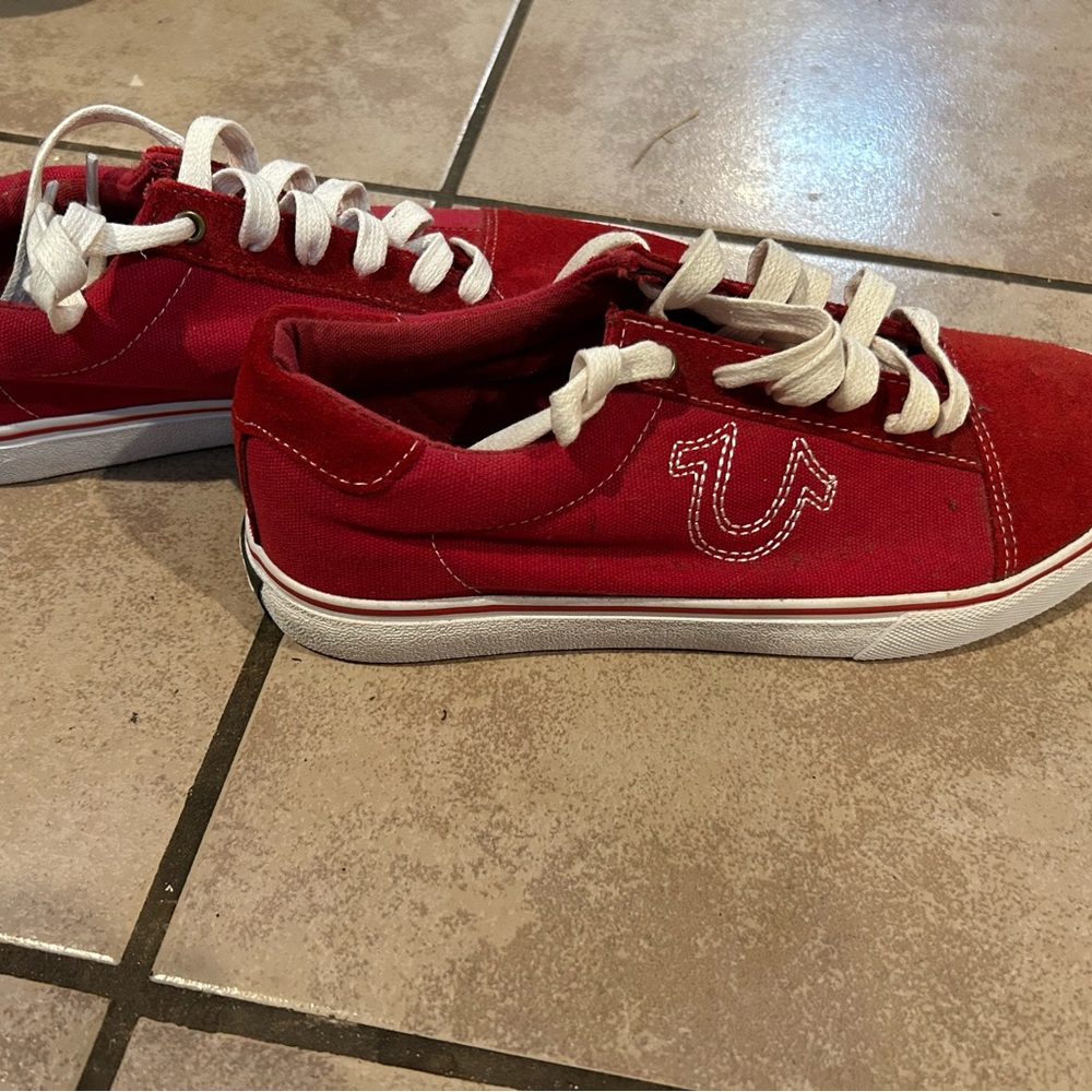 A pair of red True Religion shoes for men never worn.
